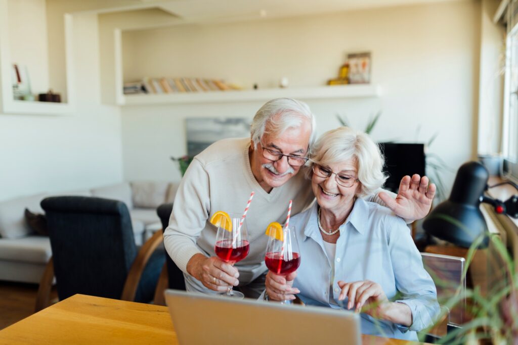 couple with cocktails watching laptop