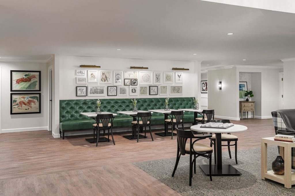 Community Common Area with Art and Seating Community common area with green upholstered bench seating and framed art on the walls.