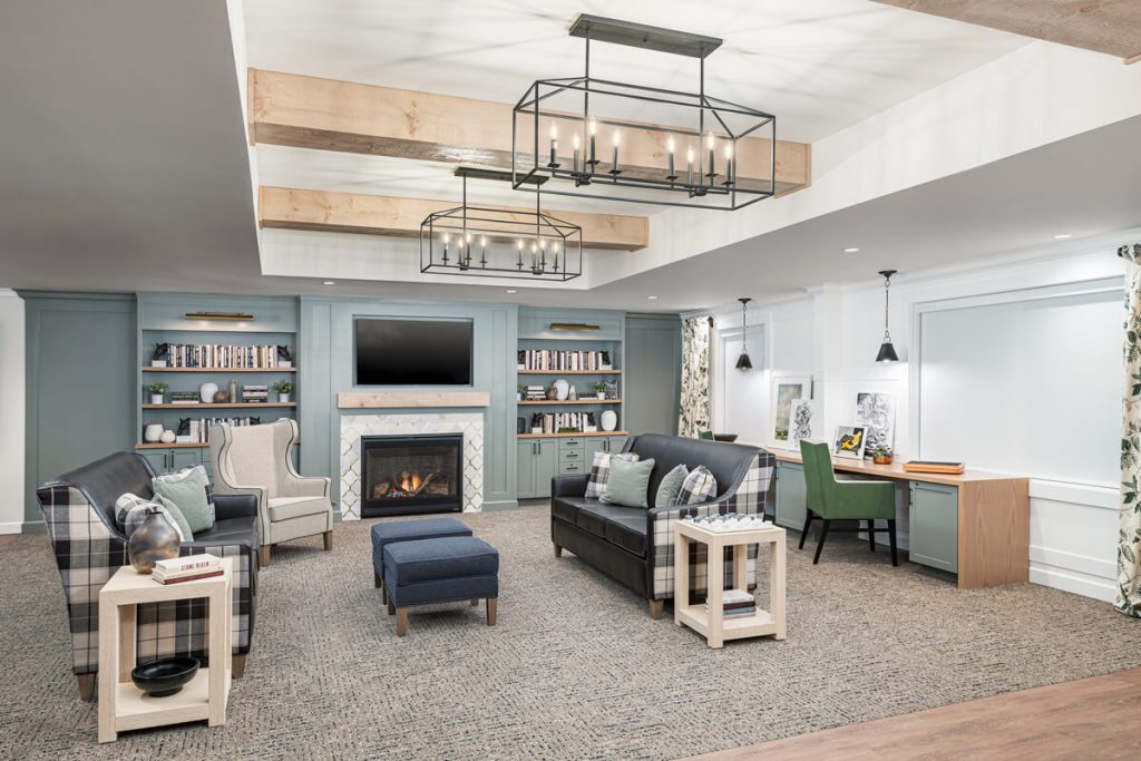 Modern Living Area in Senior Community Elegant living area in a modern senior community with seating, fireplace, and workstations.