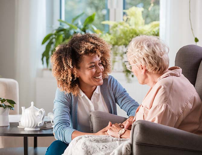 woman helping senior