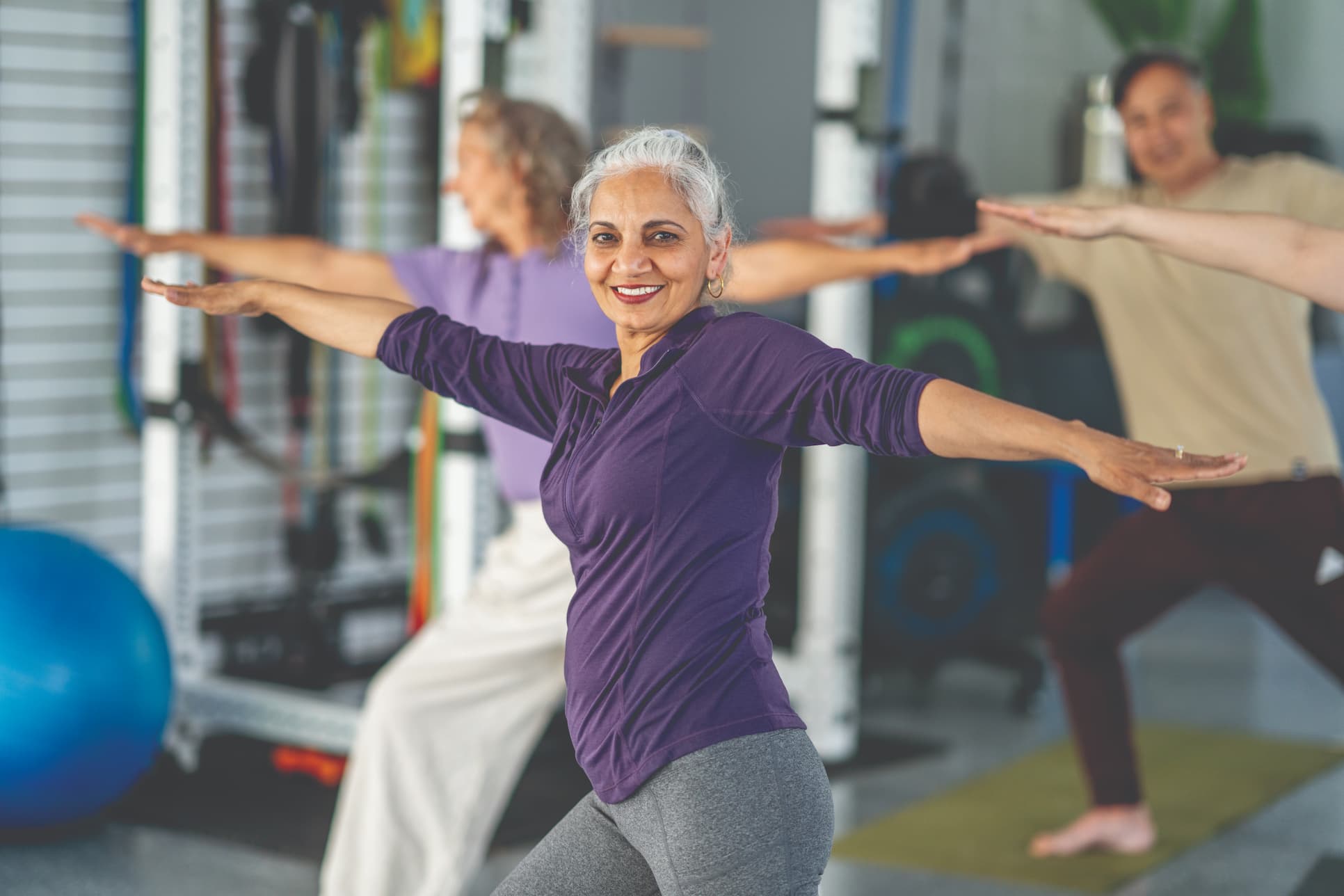 woman-stretching-in-yoga-class Senior woman stretching in yoga class